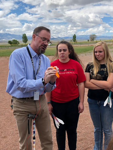 Round Mountain Students and Mr. Mac reviewing the launch