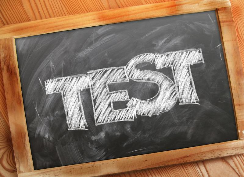 Brown framed blackboard with the word 'Test' written in block white letters.