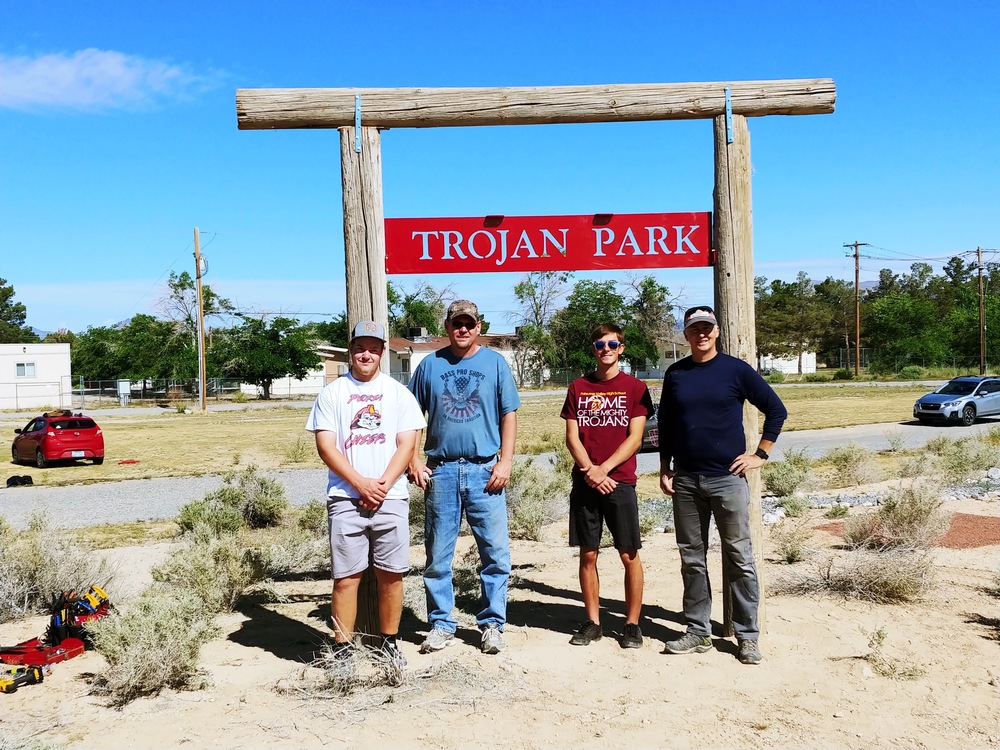Mr. Norton, Mr. Lindberg, Mr. Martin, Koby Linberg, and Jacob Cipollini install the sign at the new Trojan Park