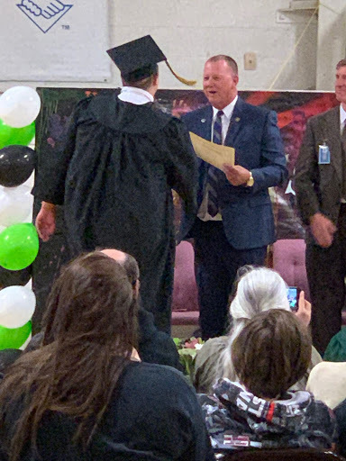 Mr. Norton congratulates a student